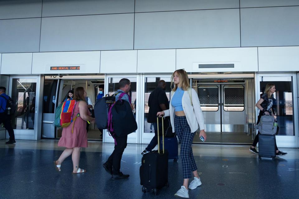 Travelers get on and off the Sky Train at Phoenix Sky Harbor Terminal 4 on June 30, 2023, in Phoenix, Ariz.