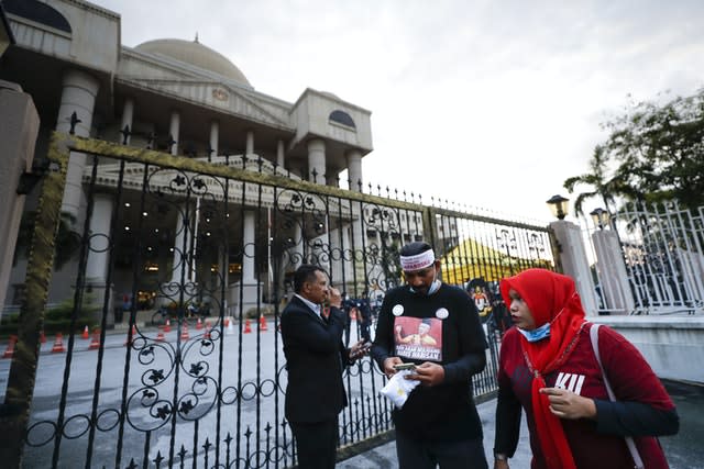 Supporters of former Malaysian prime minister Najib Razak wait outside court in Kuala Lumpur 