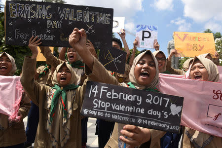Muslim students shout slogans during a protest against Valentine's Day celebrations in Surabaya, Indonesia, February 13, 2017 in this photo taken by Antara Foto. Picture taken February 13, 2017. Antara Foto/Zabur Karuru/ via REUTERS