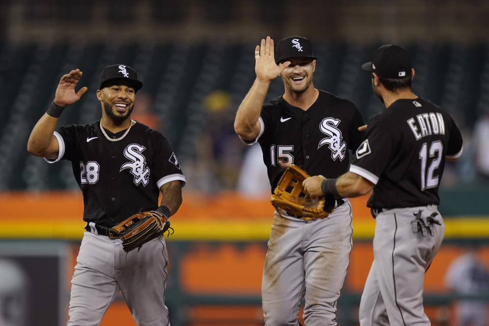 Chicago White Sox right fielder Leury Garcia (28), center fielder Adam Engel (15) and right fielder Adam Eaton (12) celebrate after the White Sox defeated the Detroit Tigers 5-4 in the 10th inning of a baseball game, Friday, June 11, 2021, in Detroit. (AP Photo/Carlos Osorio)