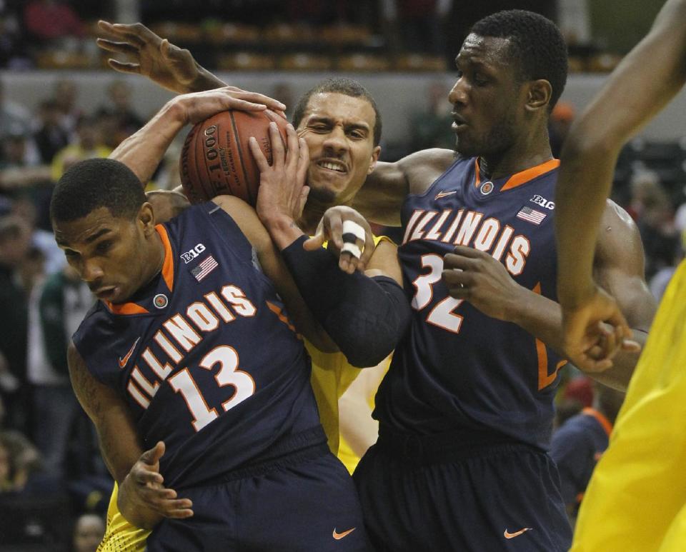 Michigan forward Jordan Morgan battles for a rebound against Illinois guard Tracy Abrams (13) and center Nnanna Egwu (32) in the first half of an NCAA college basketball game in the quarterfinals of the Big Ten Conference tournament Friday, March 14, 2014, in Indianapolis. (AP Photo/Kiichiro Sato)