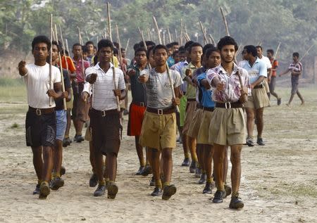 Volunteers of the Hindu nationalist organisation Rashtriya Swayamsevak Sangh (RSS) hold sticks as they march during a training session at Tatiberia village in West Bengal, India, in this May 20, 2015 file photo. REUTERS/Rupak De Chowdhuri