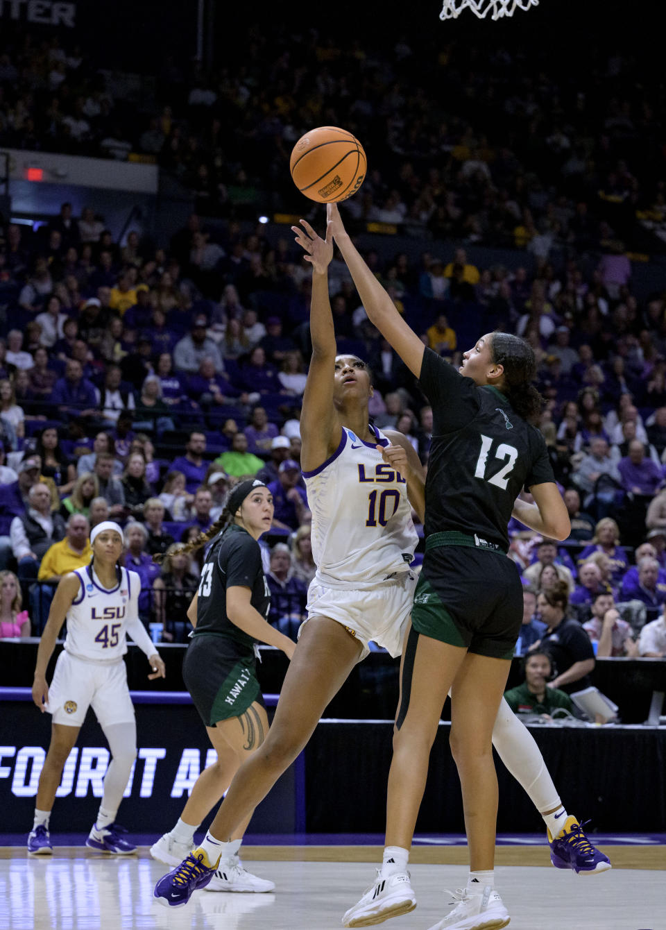 LSU forward Angel Reese (10) shoots against Hawaii forward Imani Perez (12) during the first half of a first-round college basketball game in the women's NCAA Tournament in Baton Rouge, La., Friday, March 17, 2023. (AP Photo/Matthew Hinton)