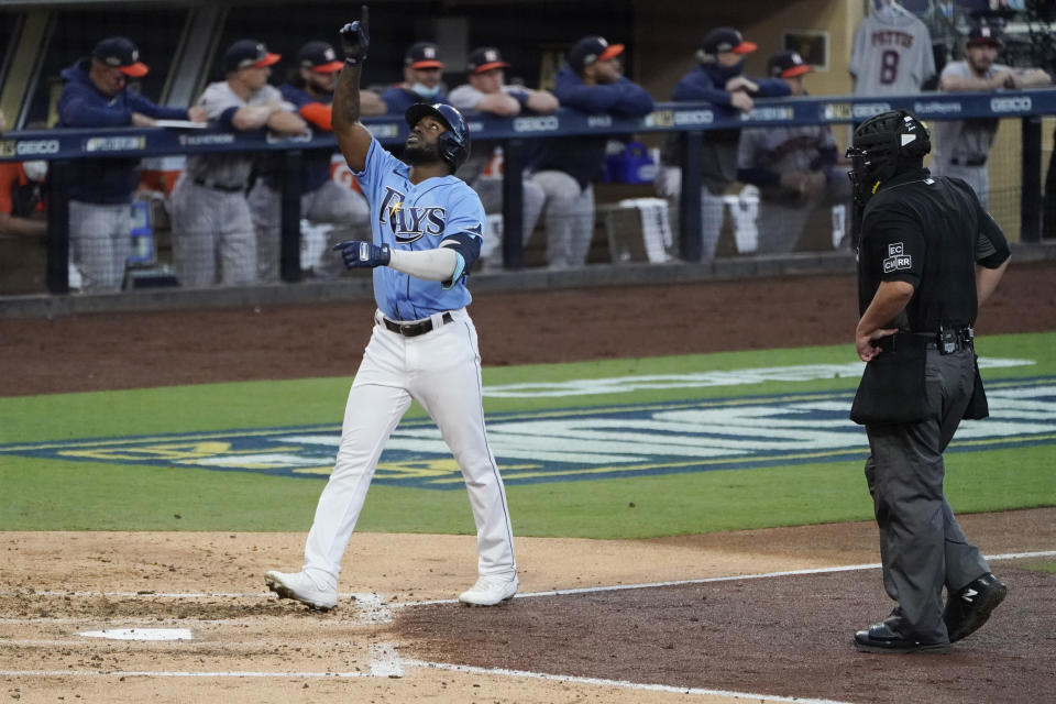 Umpire Manny Gonzalez watches Tampa Bay Rays Randy Arozarena walks to the plate after hitting a solo home run against Houston Astros starting pitcher Framber Valdez during the fourth inning in Game 1 of a baseball American League Championship Series, Sunday, Oct. 11, 2020, in San Diego. (AP Photo/Ashley Landis)