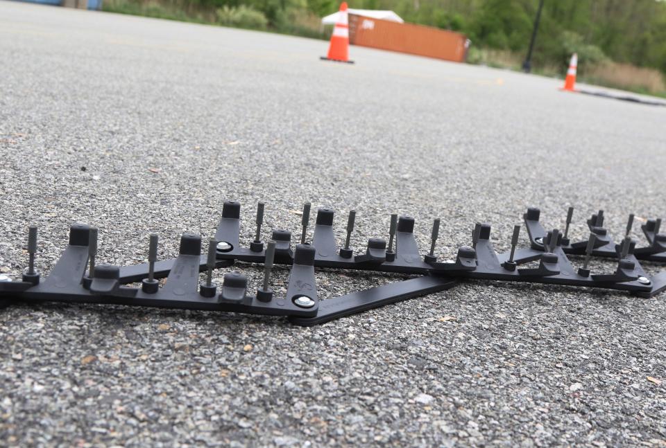 Randolph, NJ -- May 9, 2024 -- Plastic spikes used to puncture the tires on dangerous vehicles trying to elude law enforcement, are stretched across the path of the vehicles. The Morris County Prosecutor's and Sheriff's offices staged a controlled demonstration of a live tire-spike stop of a moving car to illustrate one tool they can use in combatting auto theft and other crimes involving high speed vehicles.