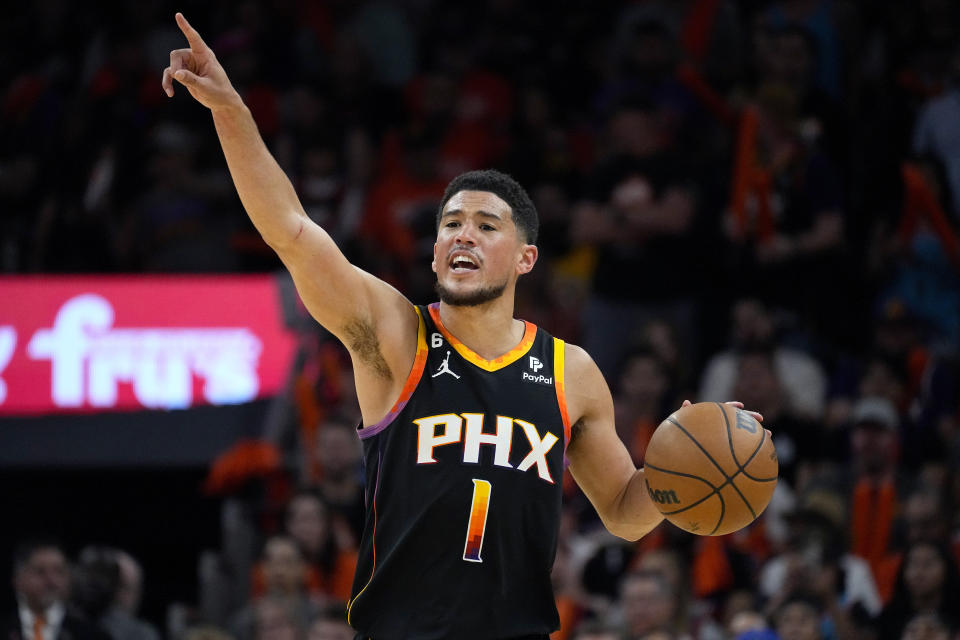 Phoenix Suns guard Devin Booker (1) calls a play against the Los Angeles Clippers during the second half of Game 5 of a first-round NBA basketball playoff series, Tuesday, April 25, 2023, in Phoenix. (AP Photo/Matt York)