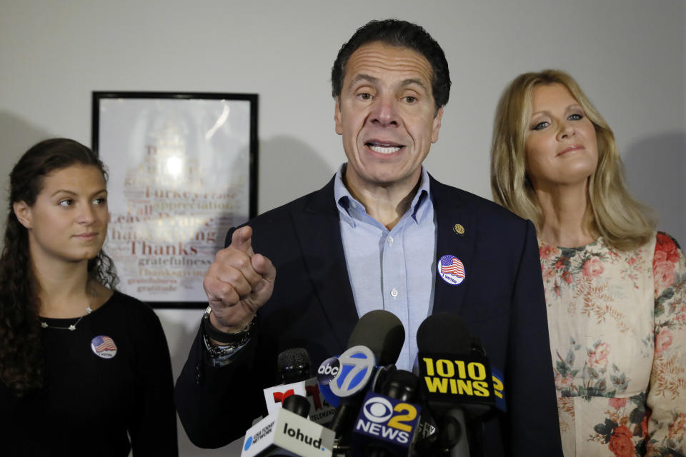 New York Gov. Andrew Cuomo, flanked by his daughter Cara Cuomo, left, and girlfriend Sandra Lee, answers media questions after voting at the Presbyterian Church of Mount Kisco, in Mt. Kisco, N.Y. Tuesday, Nov. 6, 2018. (AP Photo/Richard Drew)