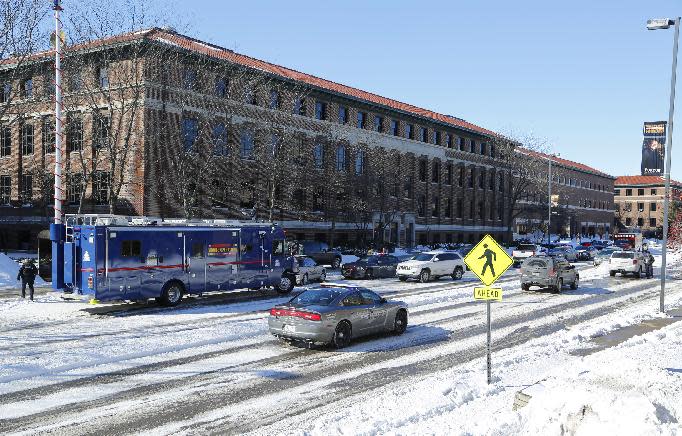 Police lockdown the area after shots were fired on Tuesday, Jan. 21, 2014, on the campus of Purdue University in West Lafayette, Ind. Officials at Purdue University say one person has been killed in a shooting at the campus classroom building. Purdue Provost Tim Sands says he didn't immediately know the identity of the person killed or the person's connection to the university. Campus police chief John Cox says the suspect is in custody after surrendering outside the Electrical Engineering Building following the shooting. (AP Photo/Journal & Courier, John Terhune) MANDATORY CREDIT