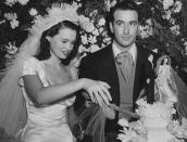 <p>Gloria Vanderbilt (a.k.a. Anderson Cooper's mother) married her first husband Pat DiCicco in 1941, when she was just 17 (and yep, she wore an iconic set of Vanderbilt pearls, because as the saying goes, "All Vanderbilt Women Have Pearls"). They divorced just four years later. (She next married Leopold Stokowski, then Sidney Lumet—more on that in the next slide—and finally, Wyatt Cooper, Anderson's father.)</p><p>Couple of fun facts: The train on Gloria's dress was 30-feet long, and that little cake topper is wearing a replica of her outfit. </p>