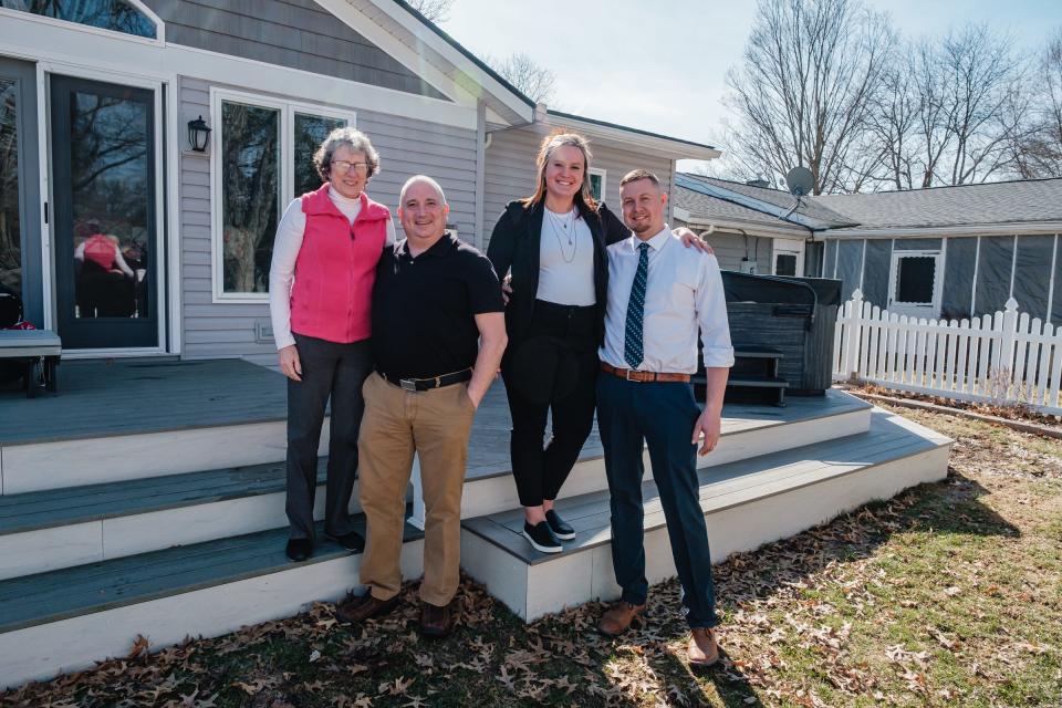 Gail and Bill Houglan, at left, pose for a picture with Michelle and Andrew Shetler, co-owners of Monumental Decks and Windows, on the Houglans' expanded deck in Dover.