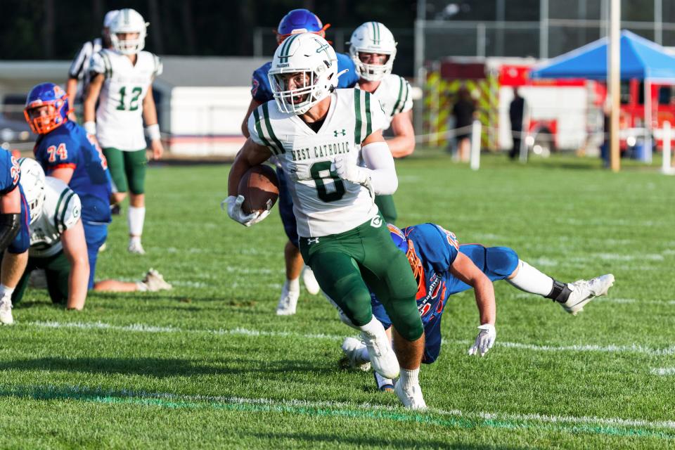 Grand Rapids West Catholics' Charlie DeBruyn (0) runs with the ball for a touchdown during the Grand Rapids West Catholic-Edwardsburg high school football game on Friday, August 25, 2023, at Leo Hoffman Field in Edwardsburg, Michigan.