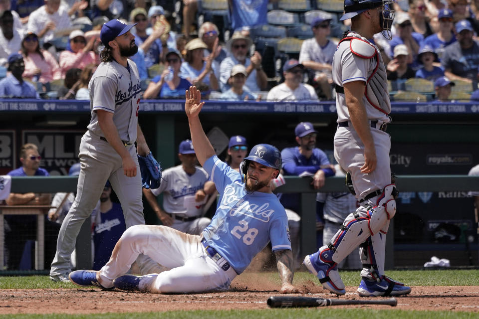 Kansas City Royals' Kyle Isbel (28) slides home to score on a two-run double hit by Nicky Lopez during the fourth inning of a baseball game against the Los Angeles Dodgers Sunday, July 2, 2023, in Kansas City, Mo. (AP Photo/Charlie Riedel)