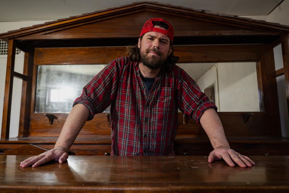 Austin Hill stands behind the bar in the possible basement speakeasy room of 1231 W. Mountain Ave. in Fort Collins on Monday. Austin and his brother, Ryan Hill, purchased the century-old home last year and were wrapping up its renovation this month.