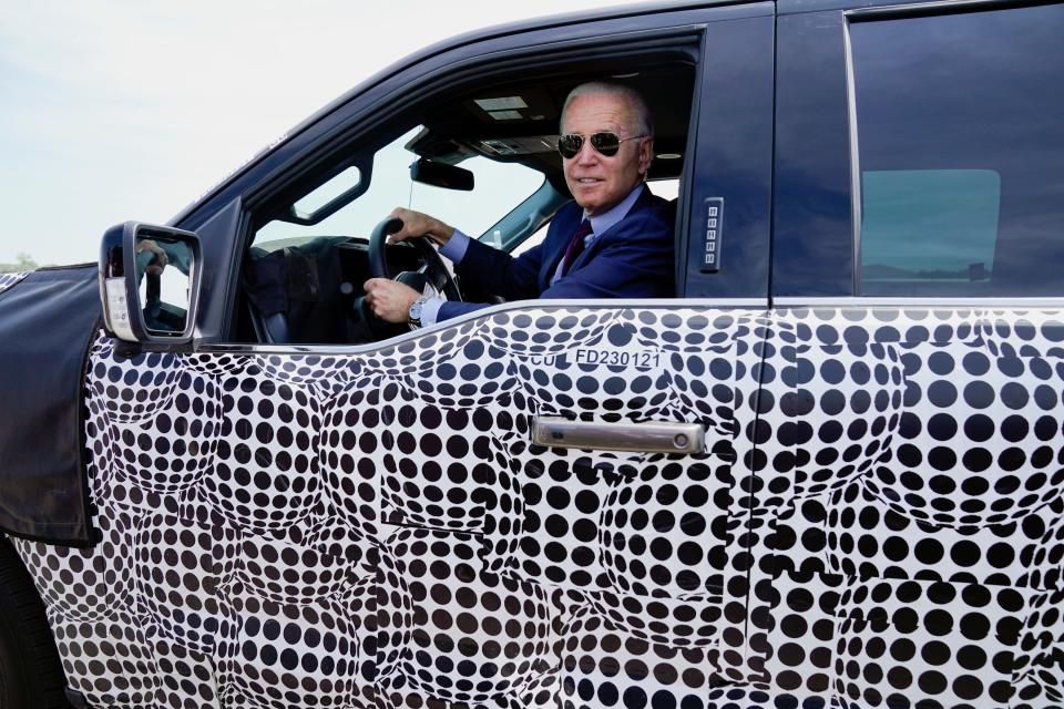 President Joe Biden stops to talk to the media as he drives a Ford F-150 Lightning truck at Ford Dearborn Development Center on Tuesday in Dearborn, Mich.