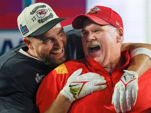 <p>Tammy Ljungblad/Kansas City Star/Tribune News Service via Getty</p> Travis Kelce (87) hugs Chiefs Head Coach Andy Reid as Tammy Reid looks on after the Chiefs won Super Bowl LVII, defeating the the Philadelphia Eagles, 38-35, on Sunday, Feb. 12, 2023, at State Farm Stadium in Glendale, Arizona.