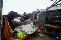 A woman salvages items from her house damaged by cyclone Amphan in Satkhira on May 21, 2020. (Photo by MUNIR UZ ZAMAN/AFP via Getty Images)