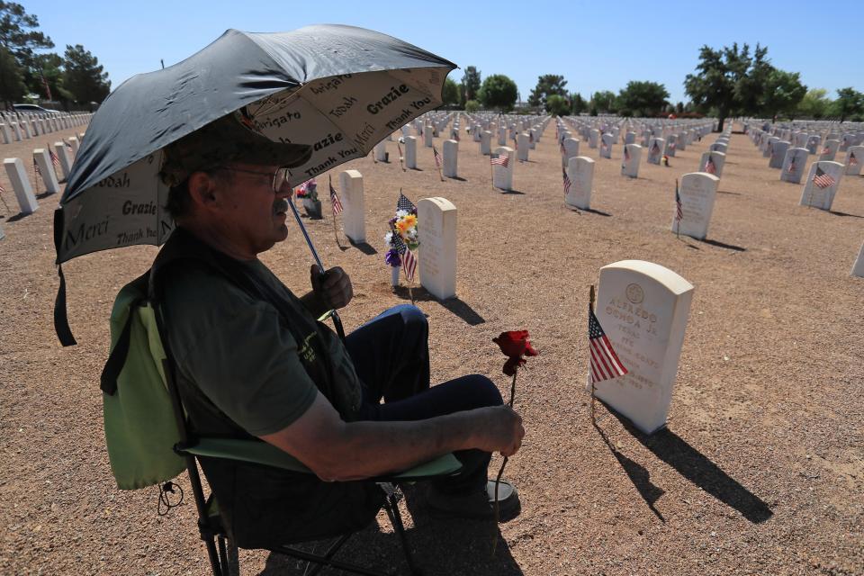 Vietnam veteran Alfredo Carlos Herrera visits the grave of his friend, Alfredo Ochoa Jr., on Memorial Day at Fort Bliss National Cemetery. The two had enlisted after graduating together from El Paso High and were sent with the 7th Battalion to Vietnam, where Ochoa was killed in 1969. For Herrera, Memorial Day means "that we must not forget all our dead who sacrificed themselves for our freedom.”