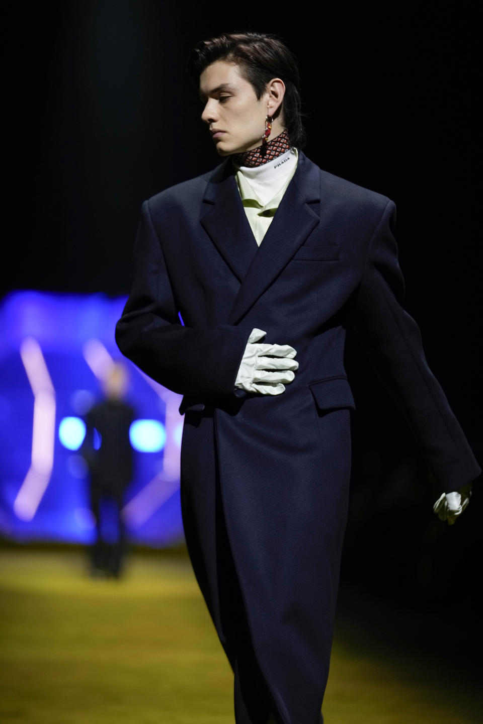 British actor Louis Partridge wears a creation as part of the Prada men's Fall-Winter 2022-23 collection, unveiled during the Fashion Week in Milan, Italy, Sunday, Jan. 16, 2022. (AP Photo/Luca Bruno)