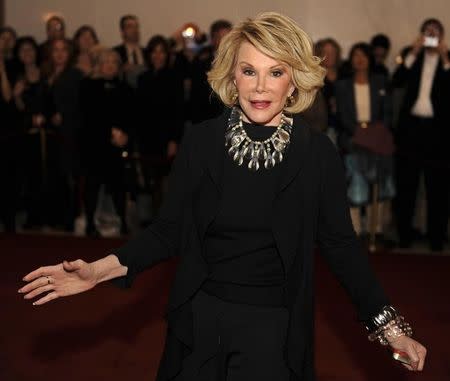 Comedian Joan Rivers poses for photographers as she arrives for the Kennedy Center's Mark Twain Prize for American Humor Gala in Washington November 10, 2008. REUTERS/Mike Theiler