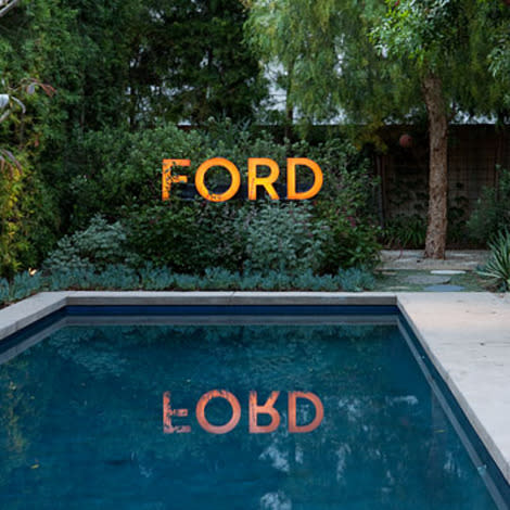 Before: Auto dealership sign, After: Poolside decor