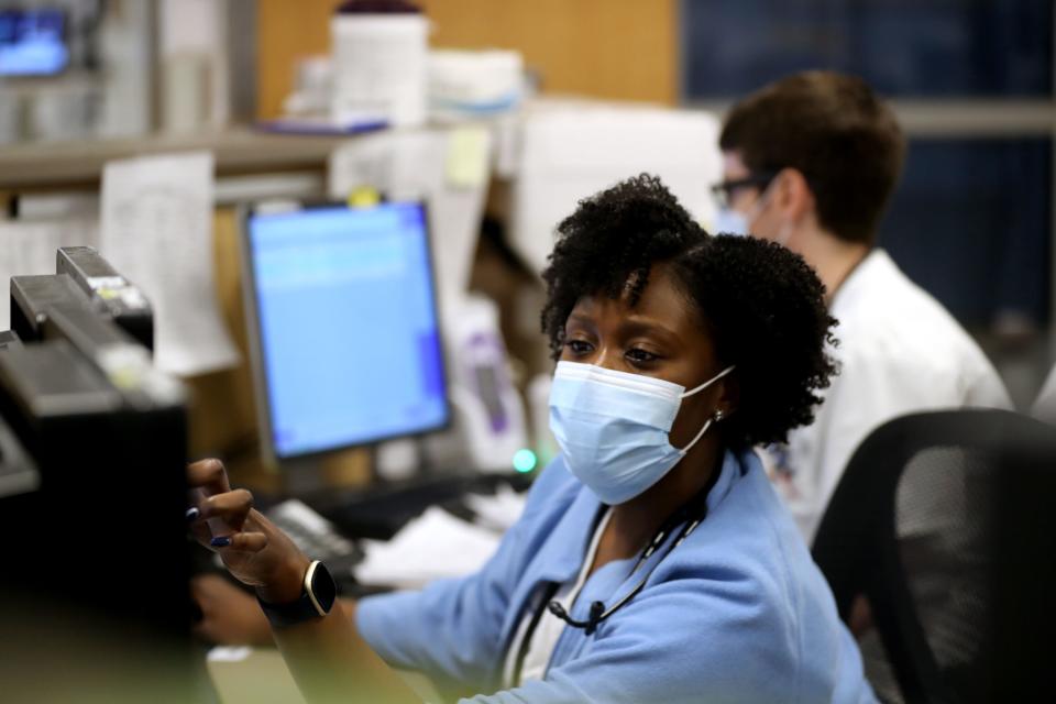 Vanessa Jean-Baptiste, a registered nurse in the intensive care unit at Northern Westchester Hospital in Mount Kisco, updates patient information at the nurses station on Feb. 28, 2022.