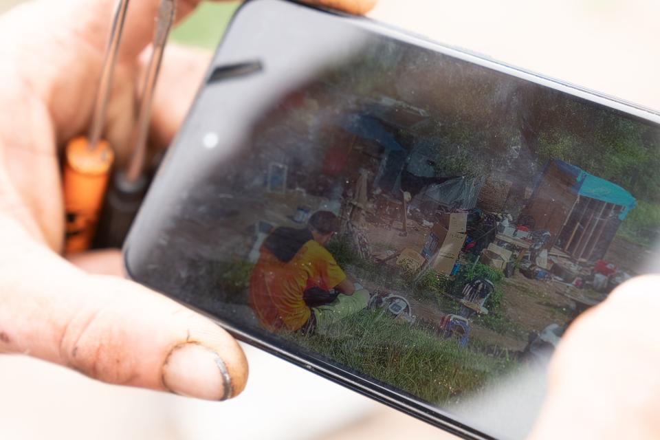 Cody Bartley shows video he took earlier this year showing a bulldozer destroying a cabin-like structure he had built at Tent City.