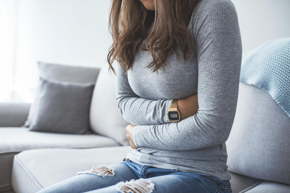 woman with sore stomach