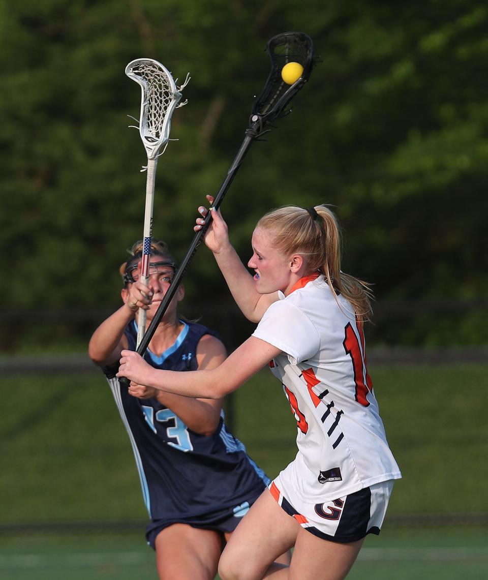 Greeley's Erica Rosendorf (10) fires a shot in front of Ursuline's Paige Moretti (13) during girls lacrosse Class A semifinal at Horace Greeley High School in Chappaqua May 23, 2023. Greeley won the game 11-8.