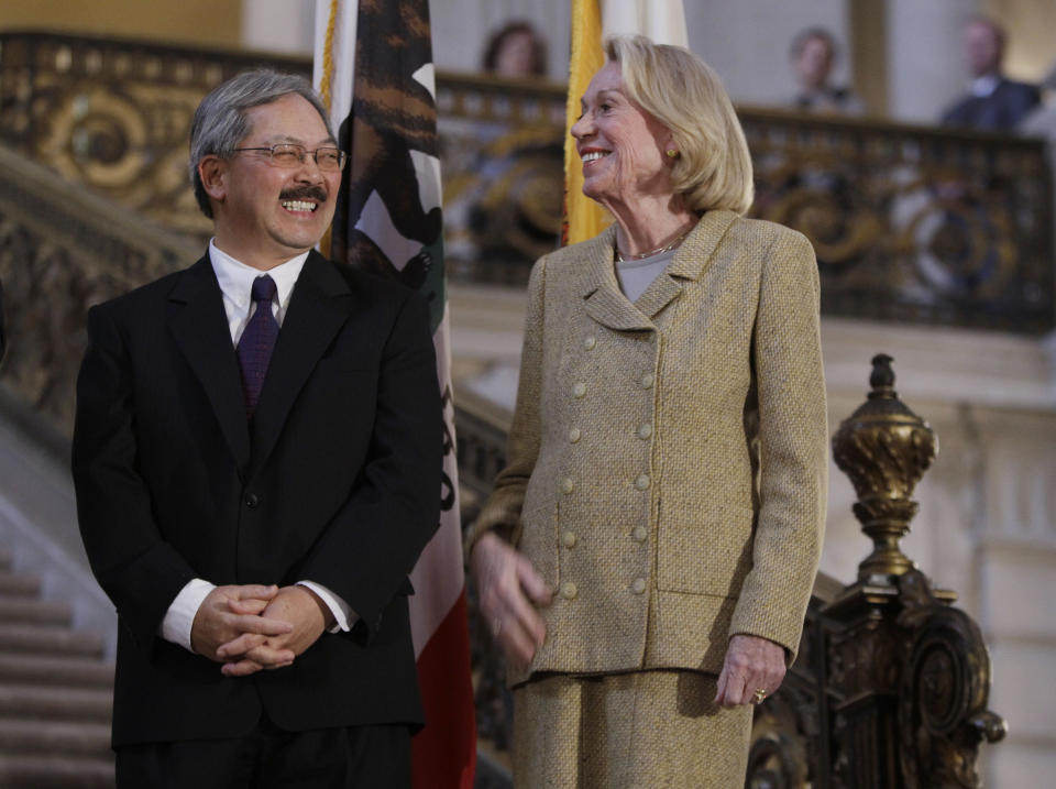 FILE - Edwin Lee, left, who was named interim mayor of San Francisco, smiles with San Francisco Chief of Protocol Charlotte Mailliard Shultz, at City Hall in San Francisco, Tuesday, Jan. 11, 2011. Shultz, the long-reigning chief of San Francisco protocol and unofficial aide to 10 mayors, died Friday, Dec. 3, 2021, of complications from cancer. She was 88. (AP Photo/Paul Sakuma, File)