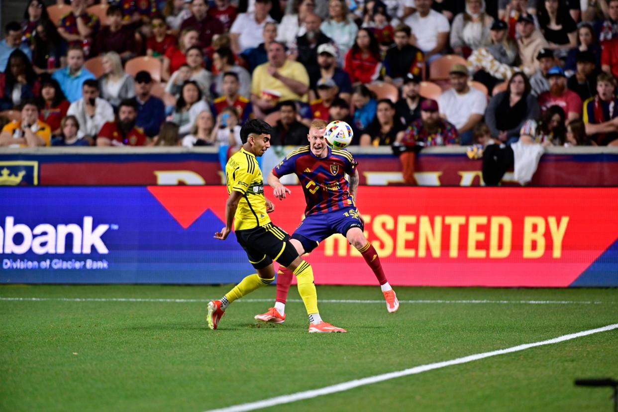 Apr 13, 2024; Sandy, Utah, USA; Real Salt Lake defender Justen Glad (15) kicks the ball past Columbus Crew forward Taha Habroune (16) during the first half at America First Field. Mandatory Credit: Christopher Creveling-USA TODAY Sports