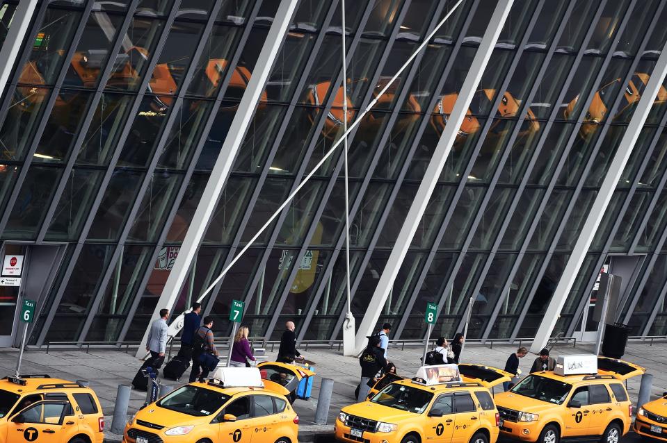 Arriving passengers line up to get taxi outside of Terminal 4 at the JFK airport in New York on October 11, 2014. The airport started health screenings for travelers arriving from Ebola-hit West African nations on October 11, as the death toll from the deadly virus topped 4,000. Passengers arriving from Liberia, Sierra Leone and Guinea will have their temperatures taken, be assessed for signs of illness and answer questions about their health and exposure history, the US Centers for Disease Control and Prevention (CDC) said.   AFP PHOTO/Jewel Samad        (Photo credit should read JEWEL SAMAD/AFP/Getty Images)