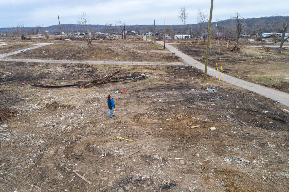 Toskia Adamson stands at the site of her mother’s home in Dawson Springs, Ky., Friday, Feb. 11, 2022. During the Dec. 10, 2021, historic quad-state tornadoes that scoured a path of destruction nearly 200 miles, most of which was in Kentucky, Adamson’s mother and son were sucked out of the home and flung into the air.