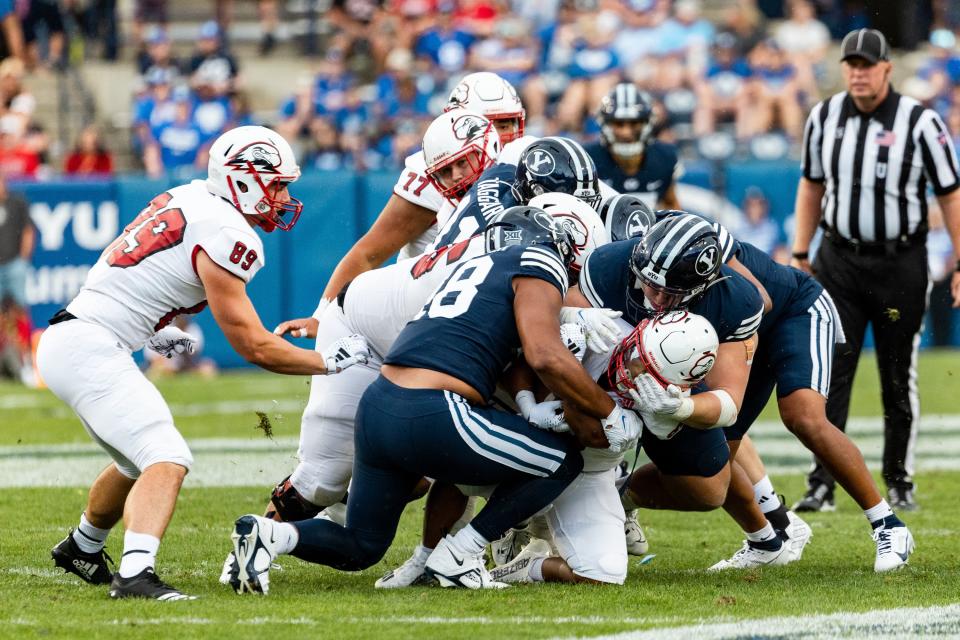 BYU defenders bring make a tackle against Southern Utah during the game at LaVell Edwards Stadium in Provo on Saturday, Sept. 9, 2023. The Cougars defense has been stout except for one category: sacks, which will come Cougar coaches say. | Megan Nielsen, Deseret News