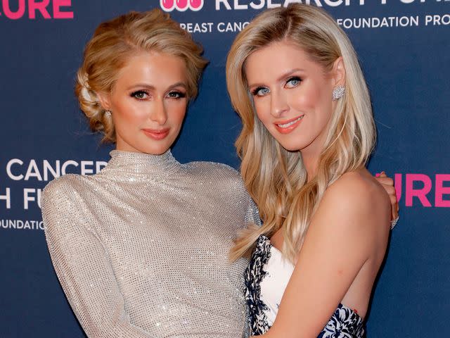 <p>Tibrina Hobson/WireImage</p> Paris and Nicky Hilton in 2020.