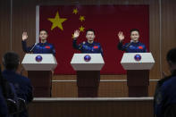 Chinese astronauts for the upcoming Shenzhou-17 mission, from left, Jiang Xinlin, Tang Hongbo, and Tang Shengjie wave upon arrival for a meeting with the press at the Jiuquan Satellite Launch Center in northwest China, Wednesday, Oct. 25, 2023. (AP Photo/Andy Wong)