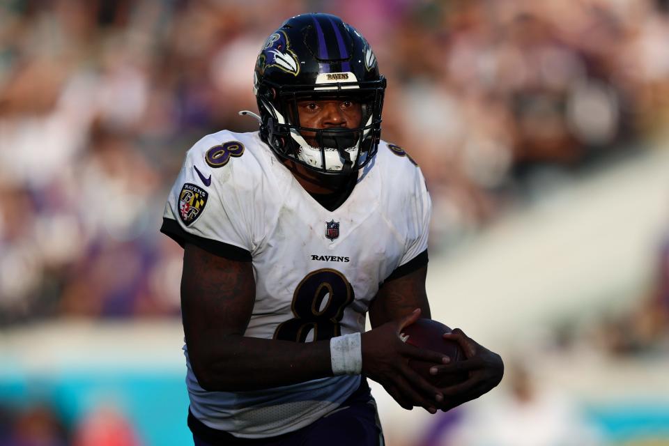 Baltimore Ravens quarterback Lamar Jackson runs with the ball against the Jacksonville Jaguars in the fourth quarter at TIAA Bank Field.