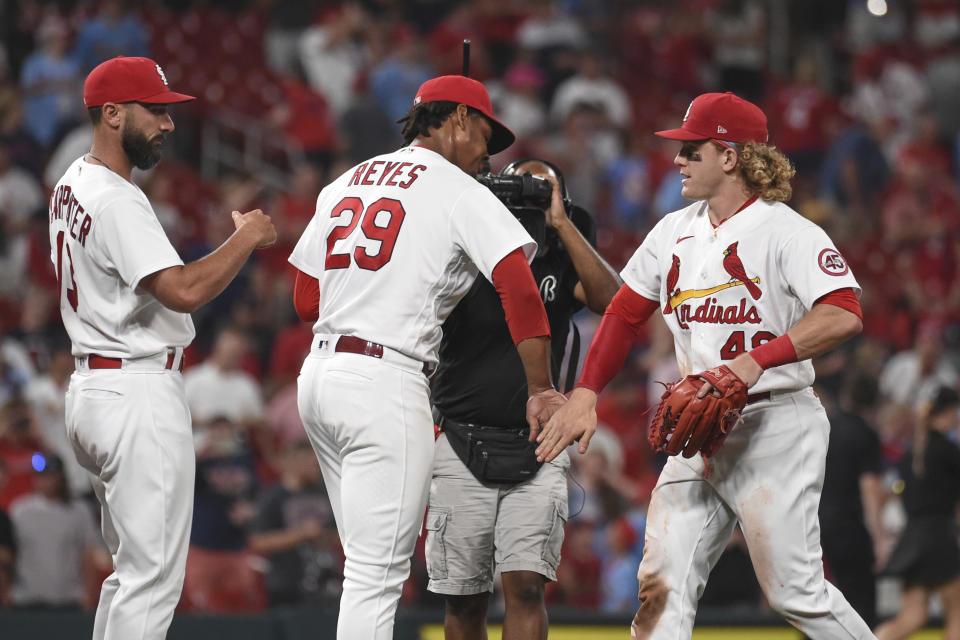 St. Louis Cardinals' Matt Carpenter, left, Alex Reyes, middle, and Harrison Bader celebrate the team's victory over the Minnesota Twins in a baseball game Friday, July 30, 2021, in St. Louis. (AP Photo/Joe Puetz)