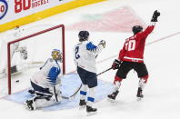 Canada's Dylan Holloway (10) reacts as the puck goes in past Finland goalie Kari Piiroinen (1) as Santeri Hatakka (2) watches during the second period of an IIHF World Junior Hockey Championship game Thursday, Dec. 31, 2020, in Edmonton, Alberta. (Jason Franson/The Canadian Press via AP)