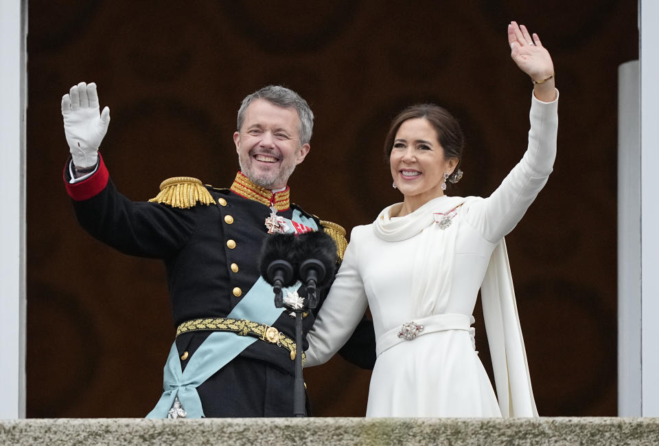 Denmark's King Frederik X and Denmark's Queen Mary wave from the balcony of Christiansborg Palace in Copenhagen, Denmark, Sunday, Jan. 14, 2024. Queen Margrethe II has become Denmark's first monarch to abdicate in nearly 900 years when she handed over the throne to her son, who has become King Frederik X. (AP Photo/Martin Meissner)