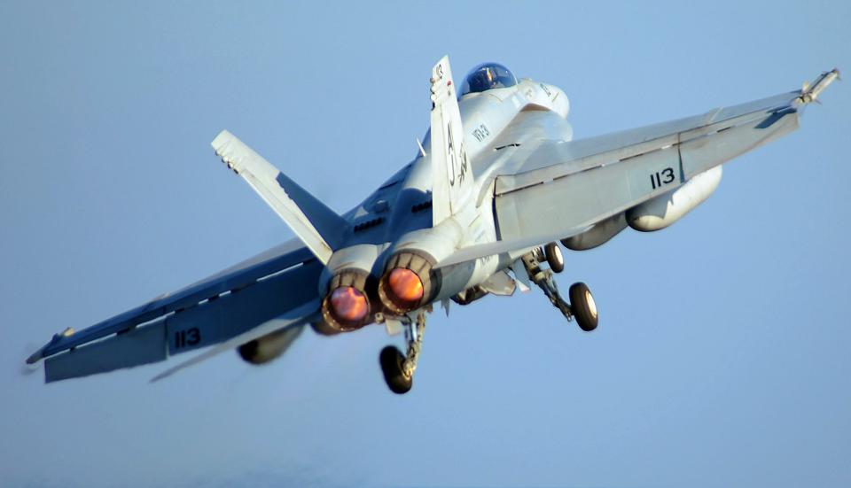 An F/A-18E in burner during departure from the boat. (U.S. Navy photo by Mass Communication Specialist 3rd Class Jonathan Snyder/Released)