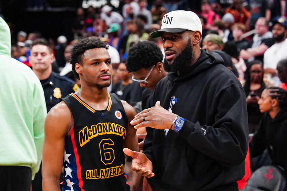 HOUSTON, TEXAS - MARCH 28: Bronny James #6 of the West team talks to Lebron James of the Los Angeles Lakers after the 2023 McDonald's High School Boys All-American Game at Toyota Center on March 28, 2023 in Houston, Texas. (Photo by Alex Bierens de Haan/Getty Images)