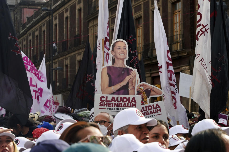 FILE - A cutout poster of ruling party presidential candidate Claudia Sheinbaum towers over supporters during her opening campaign rally at the Zocalo in Mexico City, March 1, 2024. (AP Photo/Aurea Del Rosario, File)