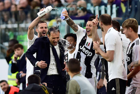 Soccer Football - Serie A - Juventus v Fiorentina - Allianz Stadium, Turin, Italy - April 20, 2019 Juventus coach Massimiliano Allegri celebrates winning the league after the match with team mates REUTERS/Massimo Pinca