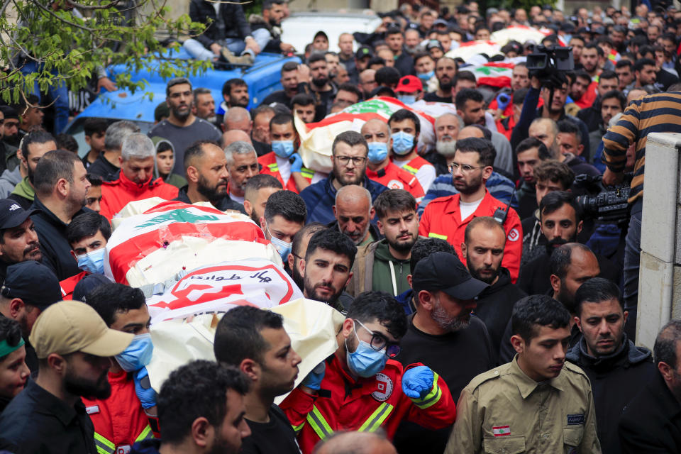 People carry the coffins of paramedics who were killed in an Israeli airstrike, during a funeral procession in Hebbariye village, south Lebanon, Wednesday, March 27, 2024. The Israeli airstrike on a paramedic center linked to a Lebanese Sunni Muslim group killed several people of its members. The strike was one of the deadliest single attacks since violence erupted along the Lebanon-Israel border more than five months ago. (AP Photo/Mohammed Zaatari)