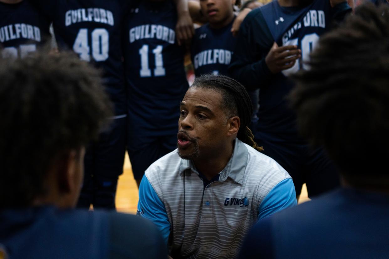 Guilford's head coach Christopher Dixon gives his team pep talk during a game against Belvidere North on Jan. 3, 2024 at Belvidere North High School.