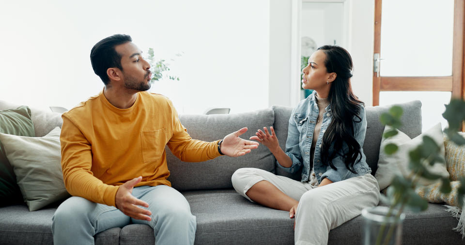 woman and man arguing on couch