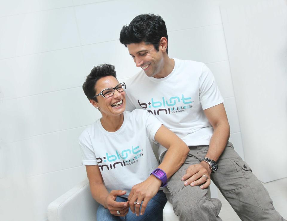 NEW DELHI, INDIA - JULY 20: Indian Bollywood director, producer and actor Farhan Akhtar and his wife Adhuna Akhtar pose for the camera during an exclusive profile shoot on July 20, 2013 in New Delhi, India. Farhan Akhtar was in town to launch his celebrity hairstylist wife Adhuna Akhtars salon. The couple has been married for 13 years, and has two daughters. Adhuna, 46, is six years older than Farhan, 39. (Photo by Raajessh Kashyap/Hindustan Times via Getty Images)