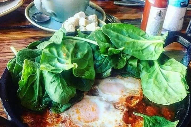 North African shakshuka - eggs baked in spicy tomato sauce with chorizo and sourdough - at Hoogah in Swansea -Credit:WalesOnline