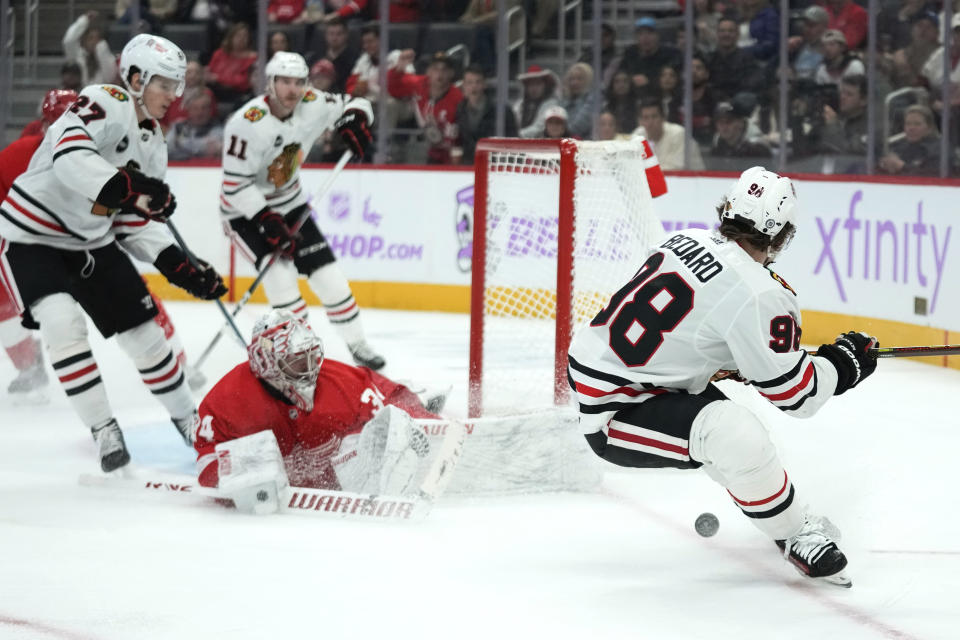 Detroit Red Wings goaltender Alex Lyon (34) stops a Chicago Blackhawks center Connor Bedard (98) shot in the third period of an NHL hockey game Thursday, Nov. 30, 2023, in Detroit. (AP Photo/Paul Sancya)