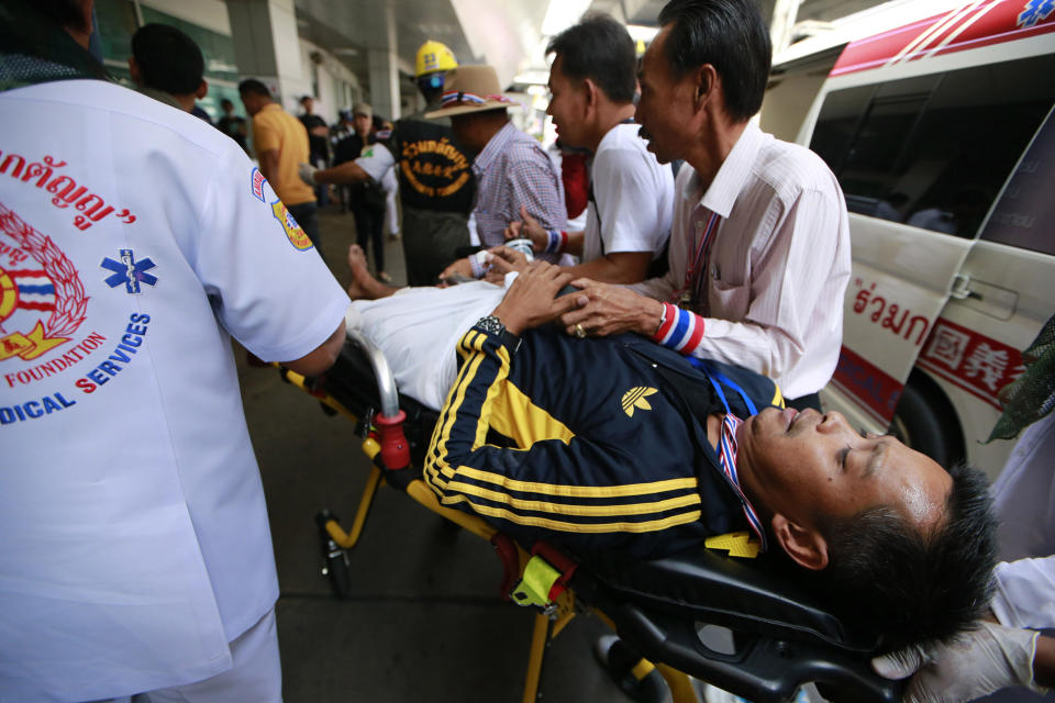 An injured anti-government protester is wheeled on a stretcher after arriving at Rama hospital in Bangkok, Thailand, Sunday, Jan. 19, 2014. Two explosions shook an anti-government demonstration site in Thailand's capital on Sunday, wounding at least 28 people in the latest violence to hit Bangkok as the nation's increasingly volatile political crisis drags on. (AP Photo/Wason Wanichakorn)